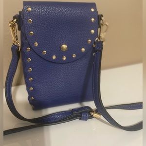 Cross body leather purple purple with silver studs w/pocket on outside.